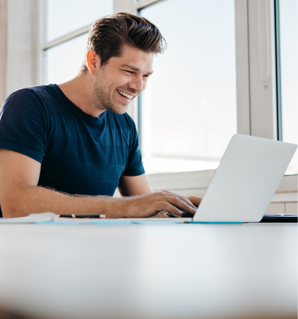 Man smiling at laptop