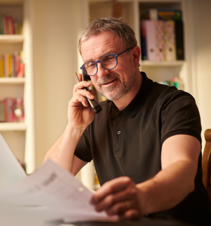 Man smiling at paperwork